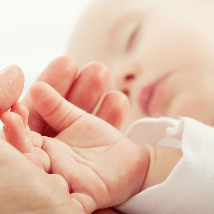 Baby sleeping with detail view hand