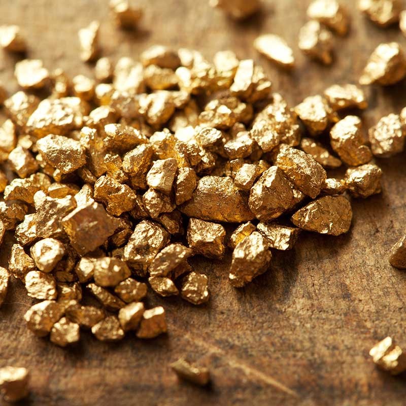Goldnuggets-Haufen auf Holztisch